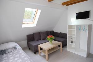 a living room with a couch and a table at Roza Wiatrow in Chłopy