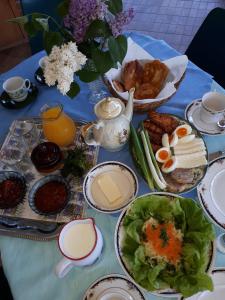 a table with a blue table cloth with food on it at Morava Garden Resort in Jagodina