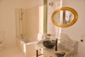 a bathroom with a sink and a mirror at Chateau De Piedouault in Jallais