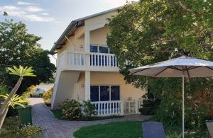 a house with an umbrella in front of it at Wayaca Mini Resort in Willemstad