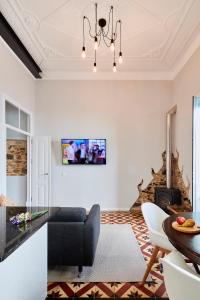 a living room with a dining table and a chandelier at Pereiras House of Charm - Downtown in Faro