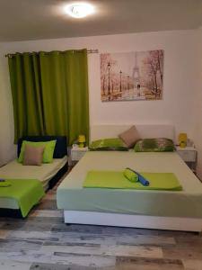 a bedroom with two beds and a green curtain at APARTMANI PAVLOVIC in Zelenika