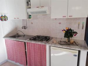 a kitchen with a sink and a counter top at Case Vacanze Giardino in Parghelia