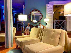 a woman sitting on a couch in a living room at Blue Horizon Boutique Resort in Vieques