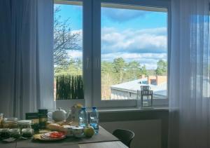 a kitchen table with a view of a window at Apartament Augustów SWAN in Augustów