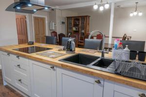 a kitchen with a sink and a counter top at Forrest's Yard - Apartment 1 in Kendal