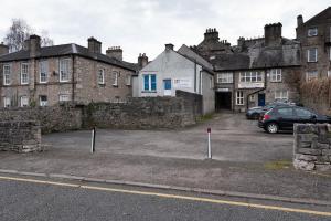 a parking lot in front of some old buildings at Forrest's Yard - Apartment 1 in Kendal