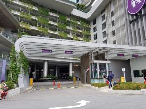 a large building with people walking in front of it at idaman Robertson residence in Kuala Lumpur