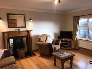 a living room with a fireplace and a tv at Atlantic View House in Killybegs