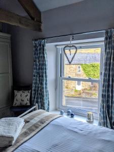 a bedroom with a bed and a window at Fell View, Slaggyford in Brampton
