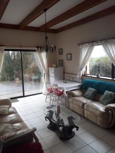 a living room with a couch and a table at Apartment in the Heart of Kerry in Knockeen Cross Roads