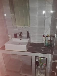 a bathroom with a white sink and a mirror at Apartment in the Heart of Kerry in Knockeen Cross Roads