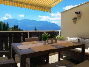 a table on a balcony with a view of mountains at Barbi Exclusive Apartment in Bad Mitterndorf +37 photos