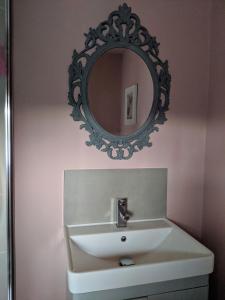 a bathroom with a sink and a mirror on the wall at Fell View, Slaggyford in Brampton
