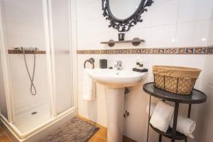 a bathroom with a sink and a shower at Apartamentos Pumarin in Santa Marina +96 photos