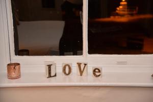 a window with the word now written on it at Lauriston & Lawton Court Hotel in Llandudno