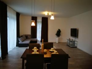 a living room with a table and a couch at Quiet Place in Achern