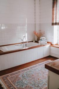 a bathroom with a bath tub and a rug at Castel Jolly in Rennes