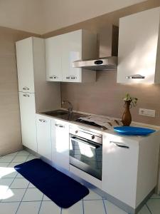 a kitchen with white cabinets and a stove top oven at casa vacanza cilento PARDALIS in Agropoli +43 photos