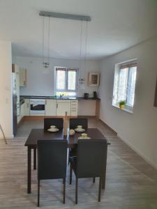 a kitchen and dining room with a table and chairs at Quiet Place in Achern