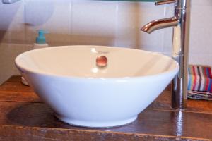 a white bowl sink with a faucet on a counter at Seesterne Residenz in Konstanz