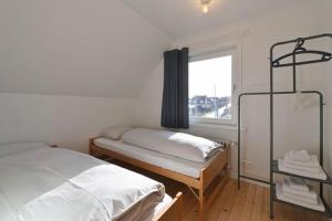 מיטה או מיטות בחדר ב-Vakantiewoning Loreley