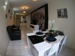 a living room with a white table and chairs at Sympathique logement en centre ville in Verdun +6 photos