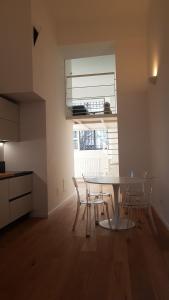a kitchen with a table and chairs in a room at Savoia 19 in Milan