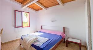 ポルティシオにあるRésidence Marina di Capitelloのベッドルーム1室(ベッド1台、窓、椅子付)