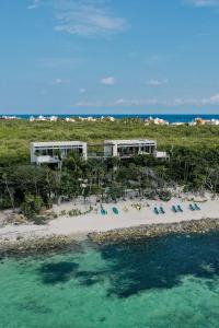 an aerial view of a beach with chairs and the ocean at Tulsayab luxury development in Tulum