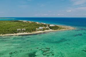 an aerial view of an island in the ocean at Tulsayab luxury development in Tulum