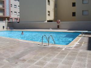 a person swimming in a swimming pool in a building at 1ª LINEA DE MAR CON VISTA FANTÁSTICA in L'Ampolla
