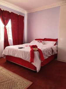 a bedroom with a large bed with red and white at Naomi's Place in Johannesburg