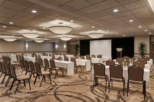 a banquet hall with white tables and chairs in a room at Holiday Inn Alexandria at Carlyle by IHG in Alexandria