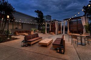 a patio with furniture and lights on a building at Holiday Inn Alexandria at Carlyle by IHG in Alexandria