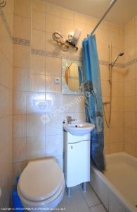 a bathroom with a toilet and a sink and a tub at Pokoje goscinne DW Antom in Dźwirzyno +18 photos
