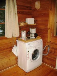 a washing machine with a coffee maker on top of it at Коттедж на берегу живописного озера in Kerimäki