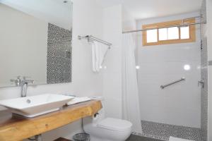 a white bathroom with a sink and a shower at Kaleo Hotel Boutique in San Salvador +56 photos