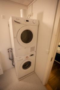 a washer and dryer in a corner of a room at Tórshavn Apartment - In The Center in Tórshavn