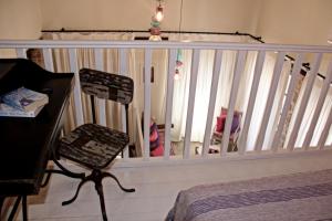 a white railing in a room with a desk and a chair at Muse Neate in Halki