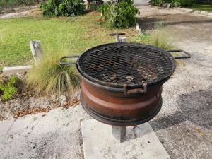 a grill sitting on the ground in a yard at Happy Forest B&B in Katima Mulilo