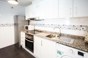 a kitchen with white cabinets and a sink at GLP ALTEA DREAMS in Altea