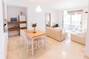 a kitchen and living room with a table and chairs at GLP ALTEA DREAMS in Altea +12 photos