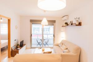 a living room with a couch and a large window at GLP ALTEA DREAMS in Altea