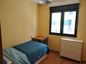 a bedroom with a bed and a window at Apartamento Playa Catedrales in Barreiros +13 photos