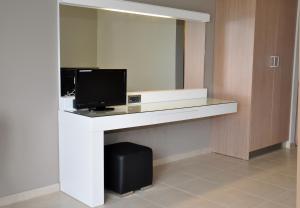 a room with a desk with a tv on it at Nautilus Bay Hotel in Kissamos