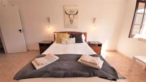 a bedroom with a large bed with two night stands at Tavira Lovers - City Centre Apartment III in Tavira