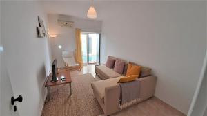 a living room with a couch and a table at Tavira Lovers - City Centre Apartment III in Tavira