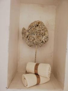 a pair of towels and a fish on a wall at Lithos Residence Poros in Poros