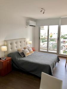 a bedroom with a bed with two pillows on it at Buenos Aires 22 in Rosario